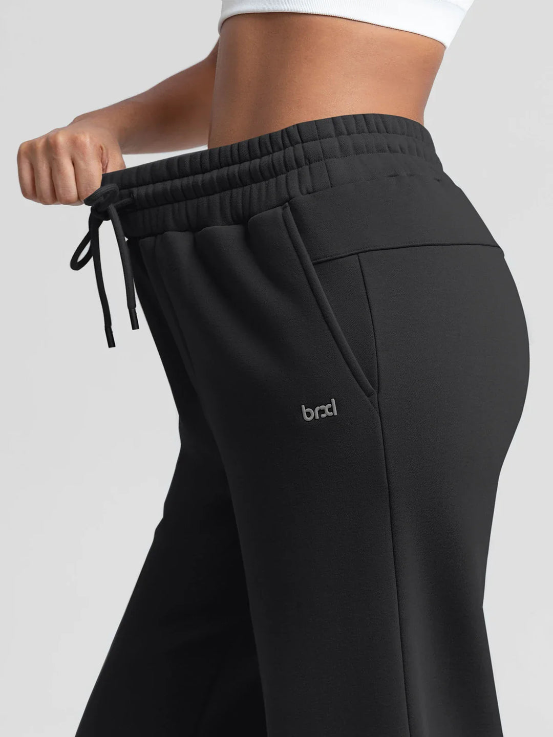 A model wearing a BRXL® Oversized Fleece Travel Jogger Sweatpants with Pockets