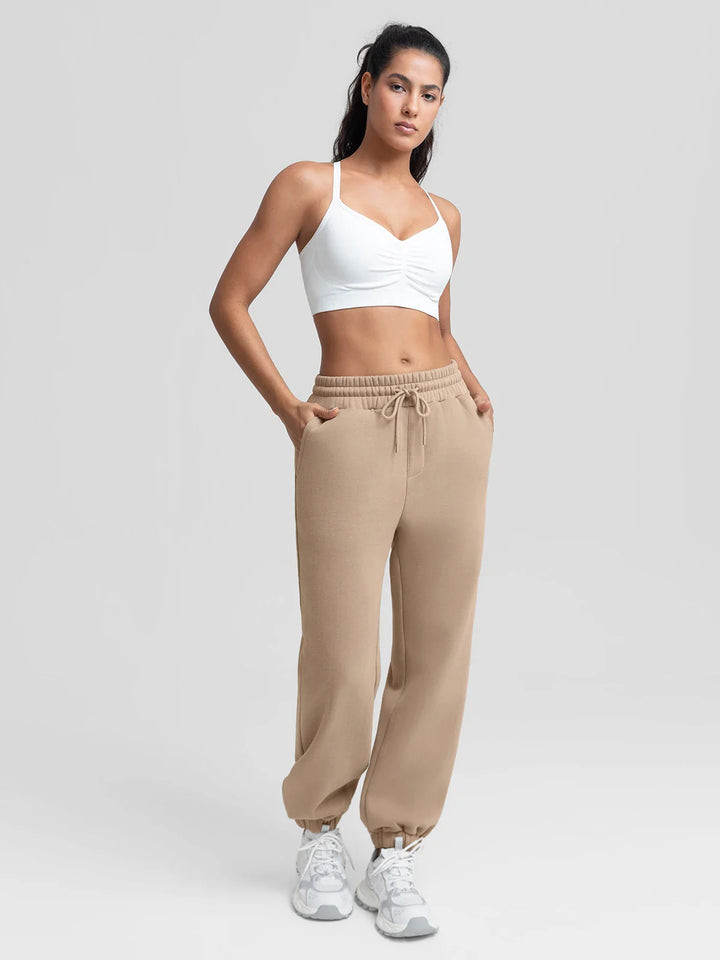 A model wearing a BRXL® Oversized Fleece Travel Jogger Sweatpants with Pockets