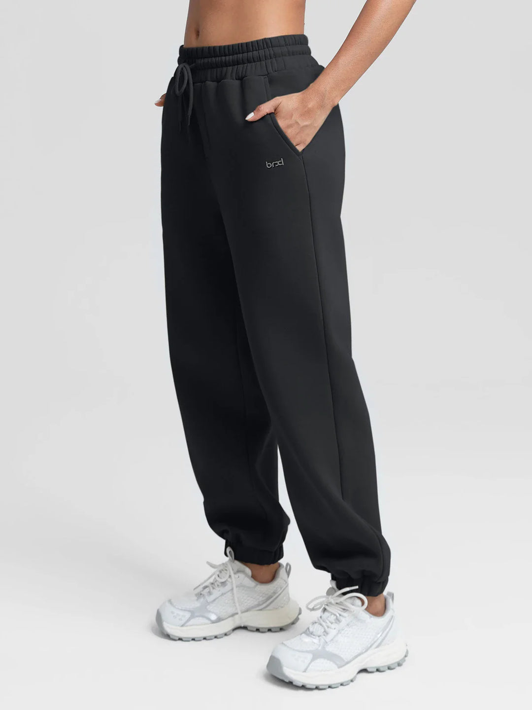 A model wearing a BRXL® Oversized Fleece Travel Jogger Sweatpants with Pockets