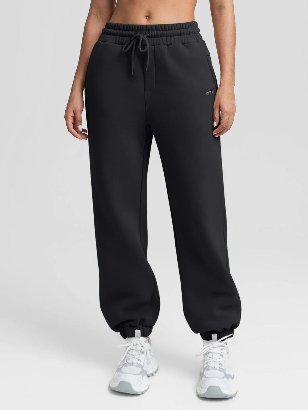 A model wearing a BRXL® Oversized Fleece Travel Jogger Sweatpants with Pockets Black / XS