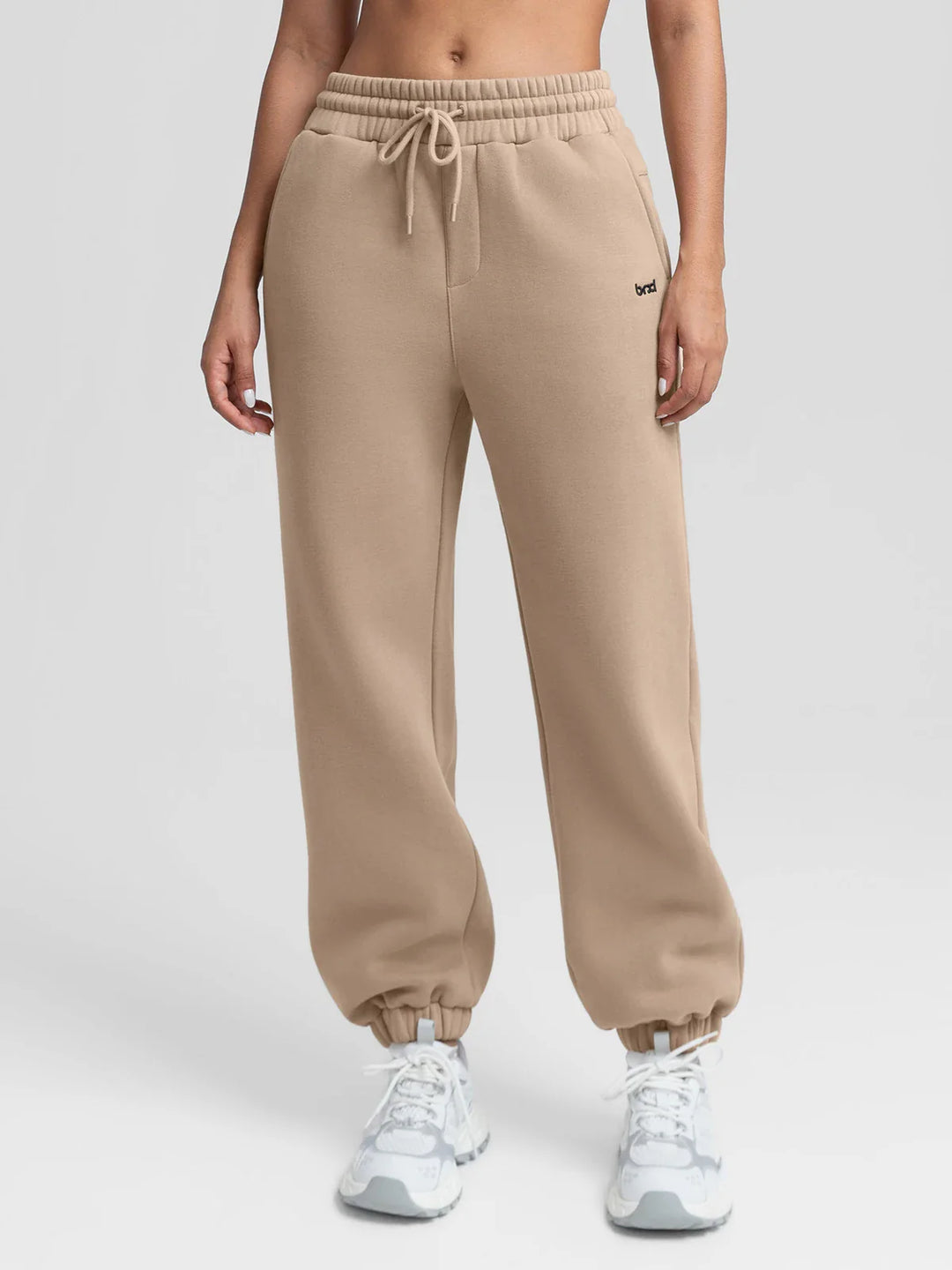 A model wearing a BRXL® Oversized Fleece Travel Jogger Sweatpants with Pockets Walnut Brown / XS