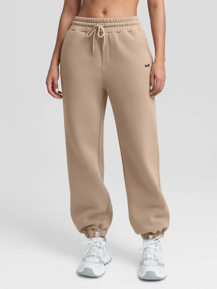 A model wearing a BRXL® Oversized Fleece Travel Jogger Sweatpants with Pockets Walnut Brown / XS