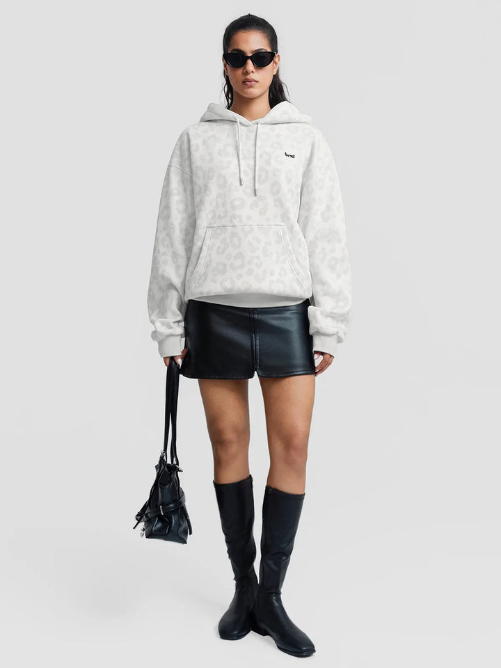 A model wearing a BRXL® Oversized Travel Pullover Hoodie with Headphone Slot
