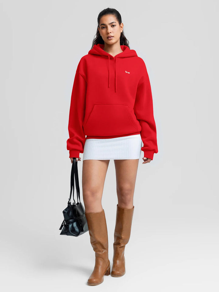 A model wearing a BRXL® Oversized Travel Pullover Hoodie with Headphone Slot