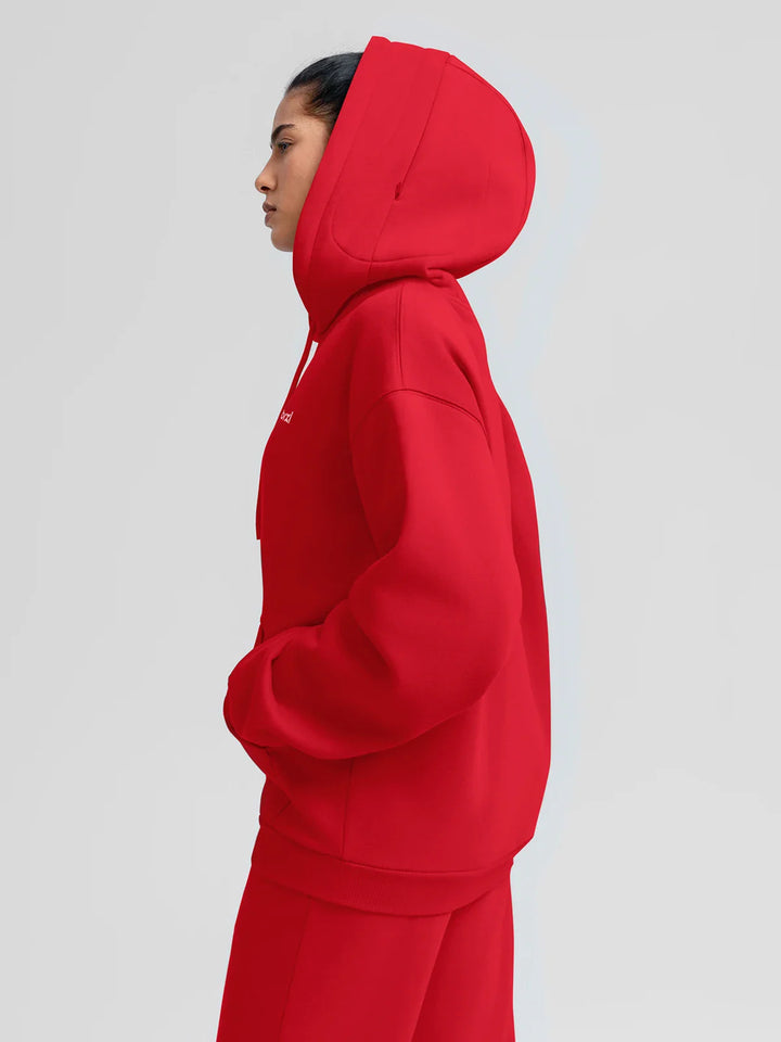 A model wearing a BRXL® Oversized Travel Pullover Hoodie with Headphone Slot