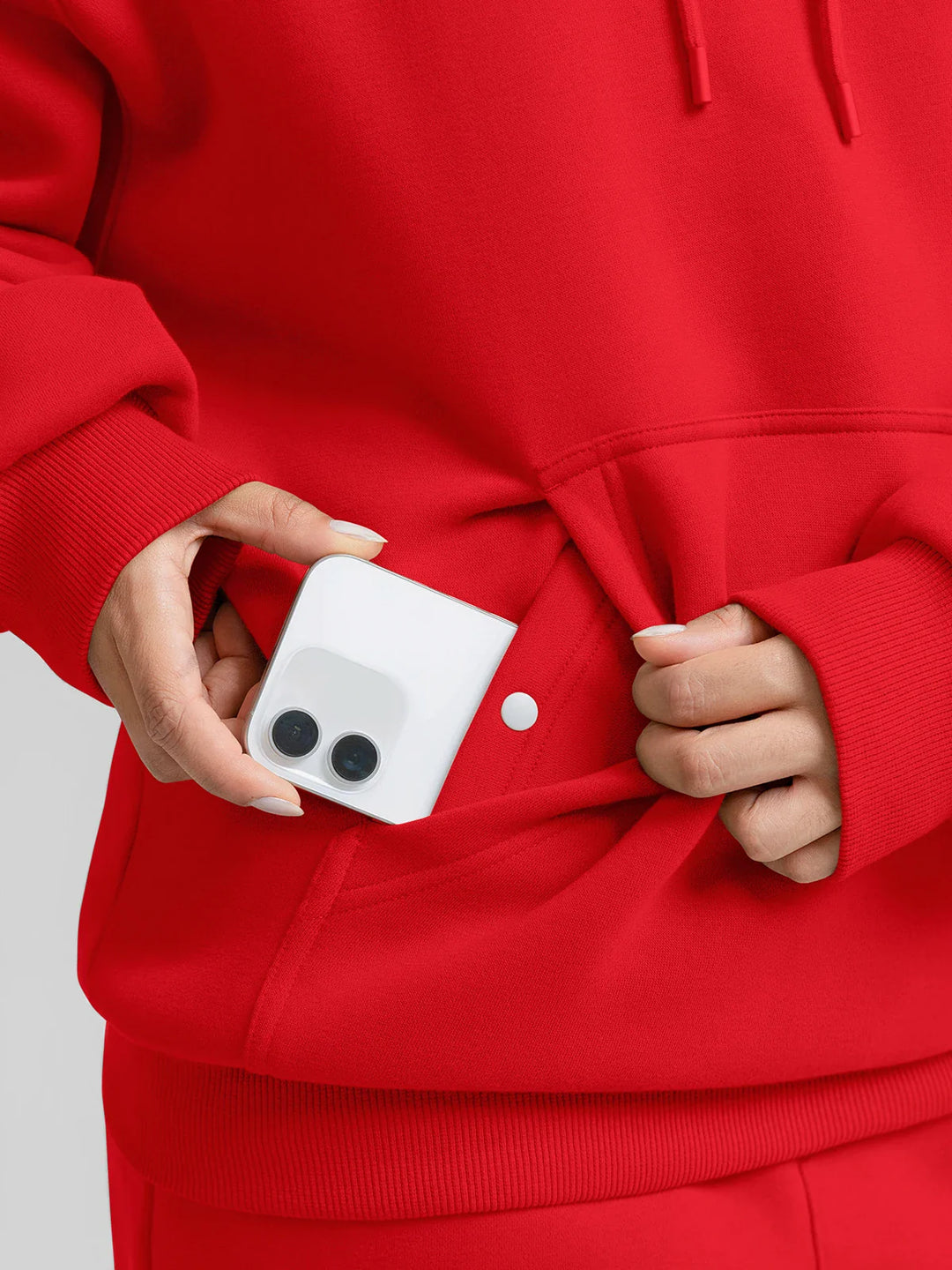 A model wearing a BRXL® Oversized Travel Pullover Hoodie with Headphone Slot