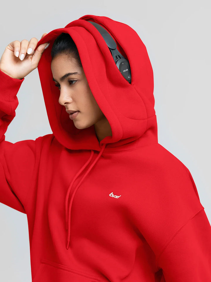 A model wearing a BRXL® Oversized Travel Pullover Hoodie with Headphone Slot