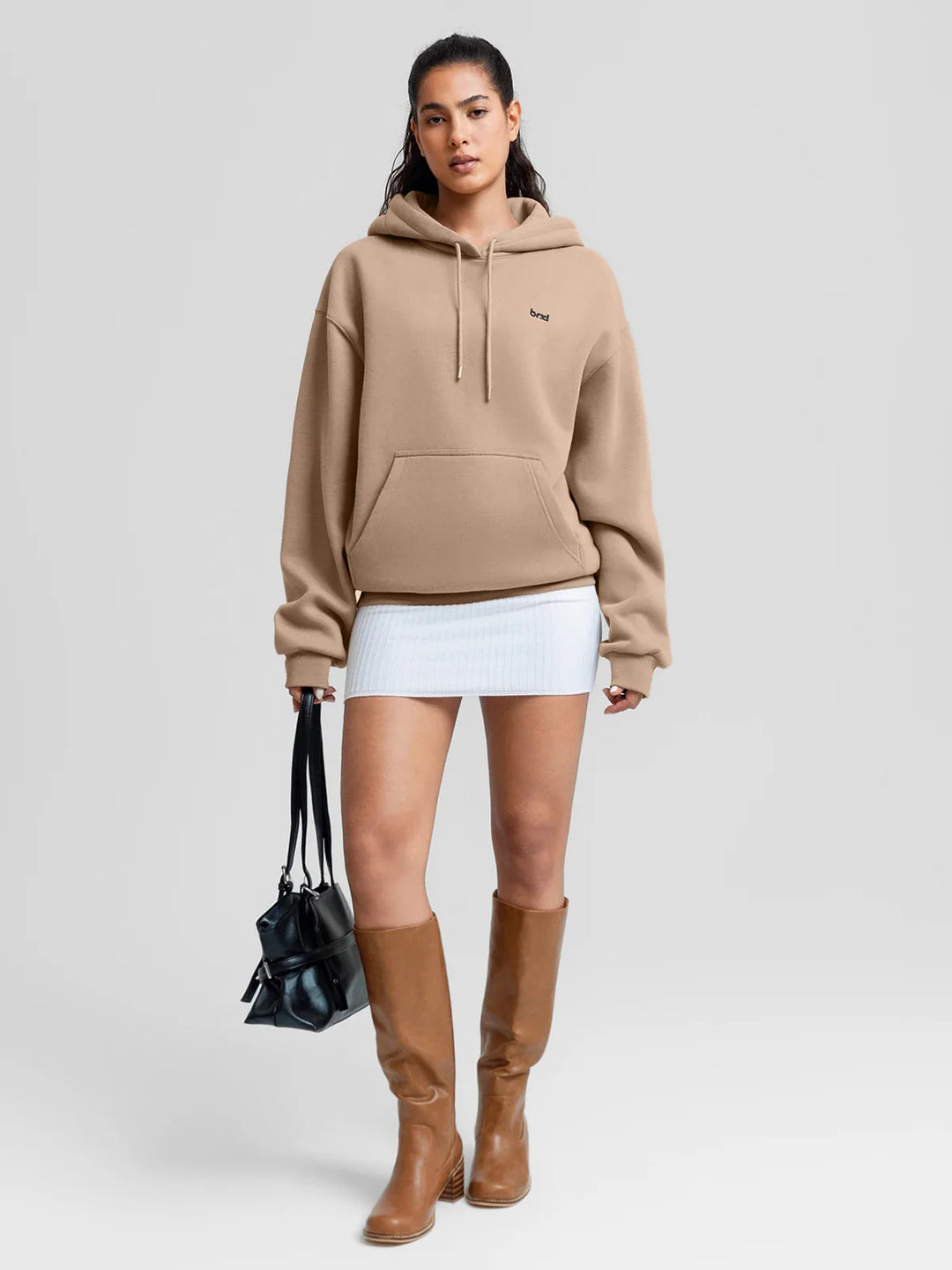 A model wearing a BRXL® Oversized Travel Pullover Hoodie with Headphone Slot