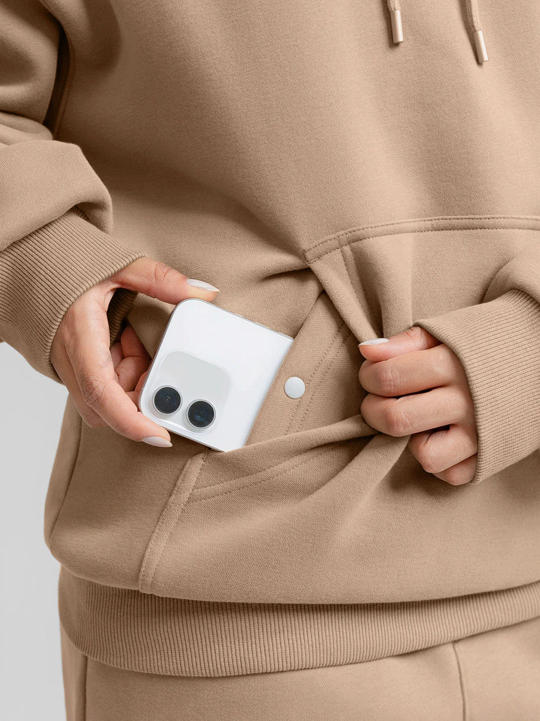 A model wearing a BRXL® Oversized Travel Pullover Hoodie with Headphone Slot