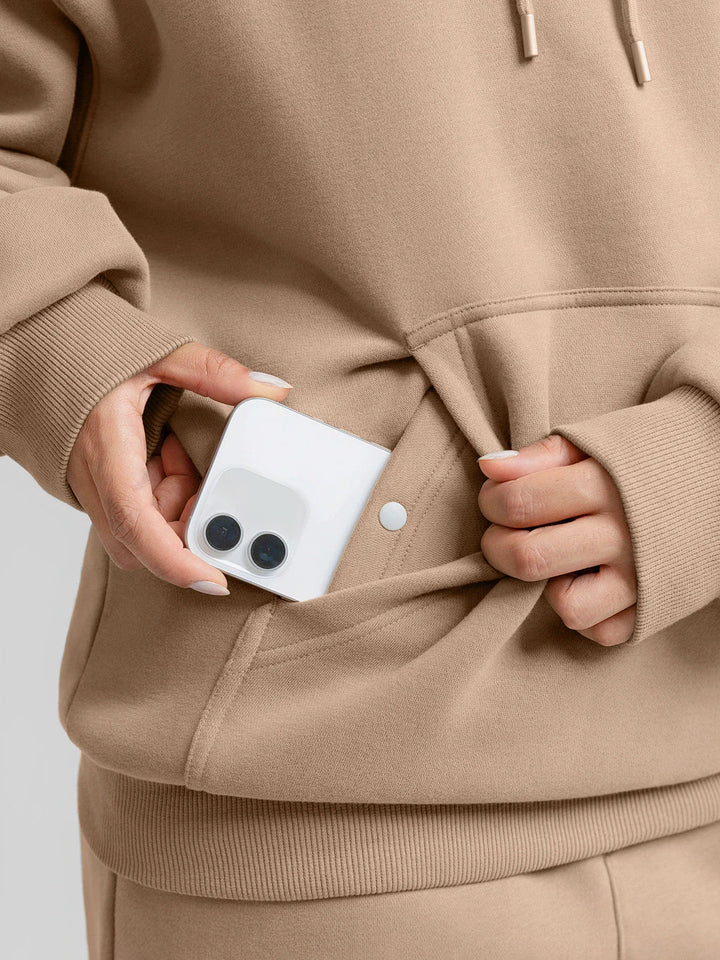A model wearing a BRXL® Oversized Travel Pullover Hoodie with Headphone Slot