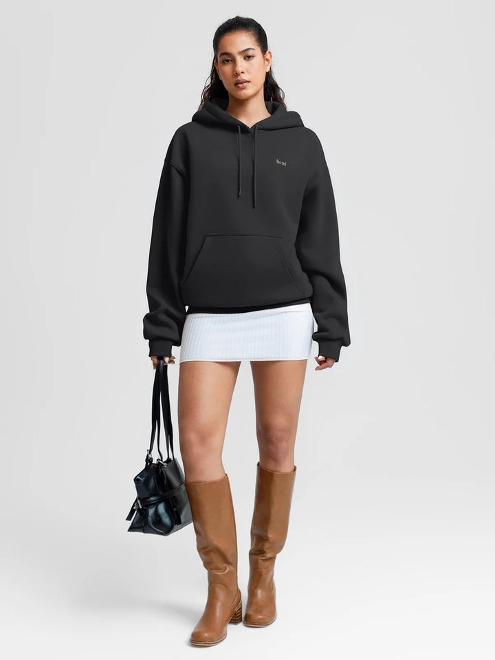 A model wearing a BRXL® Oversized Travel Pullover Hoodie with Headphone Slot