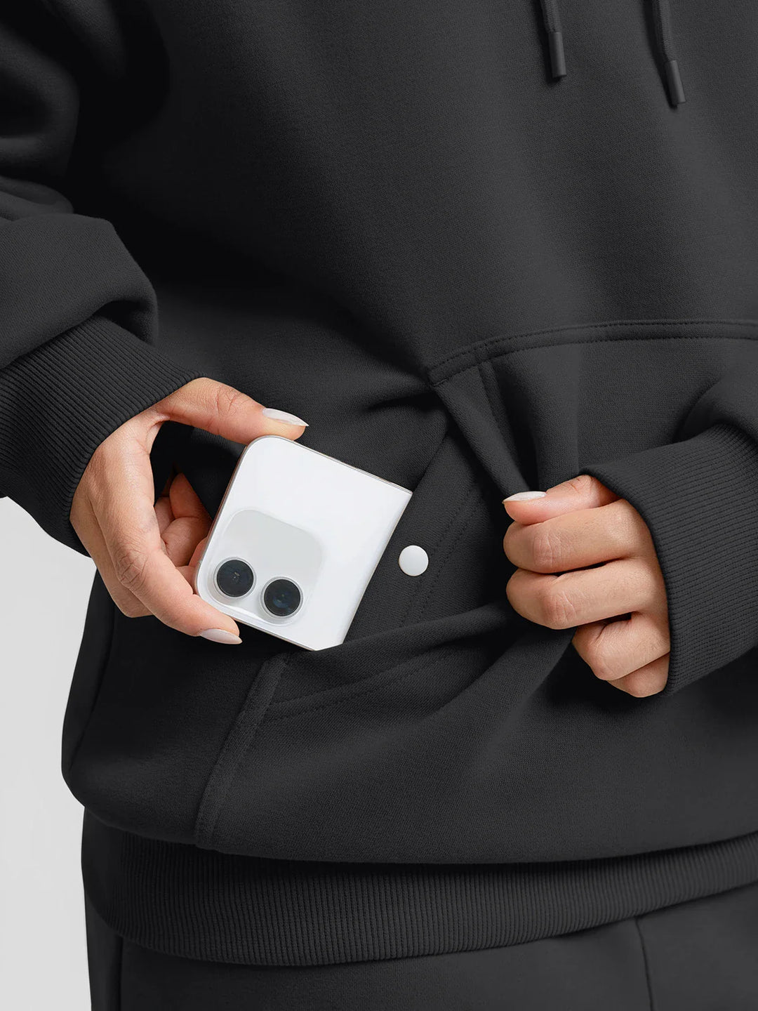 A model wearing a BRXL® Oversized Travel Pullover Hoodie with Headphone Slot