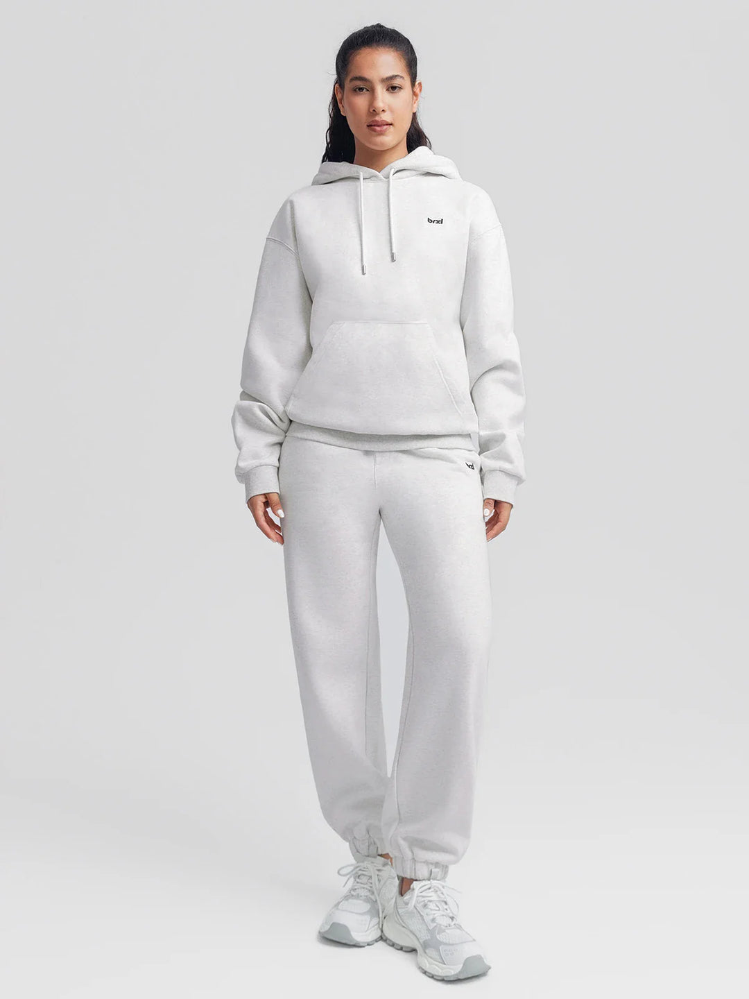 A model wearing a BRXL® Oversized Travel Pullover Hoodie with Headphone Slot