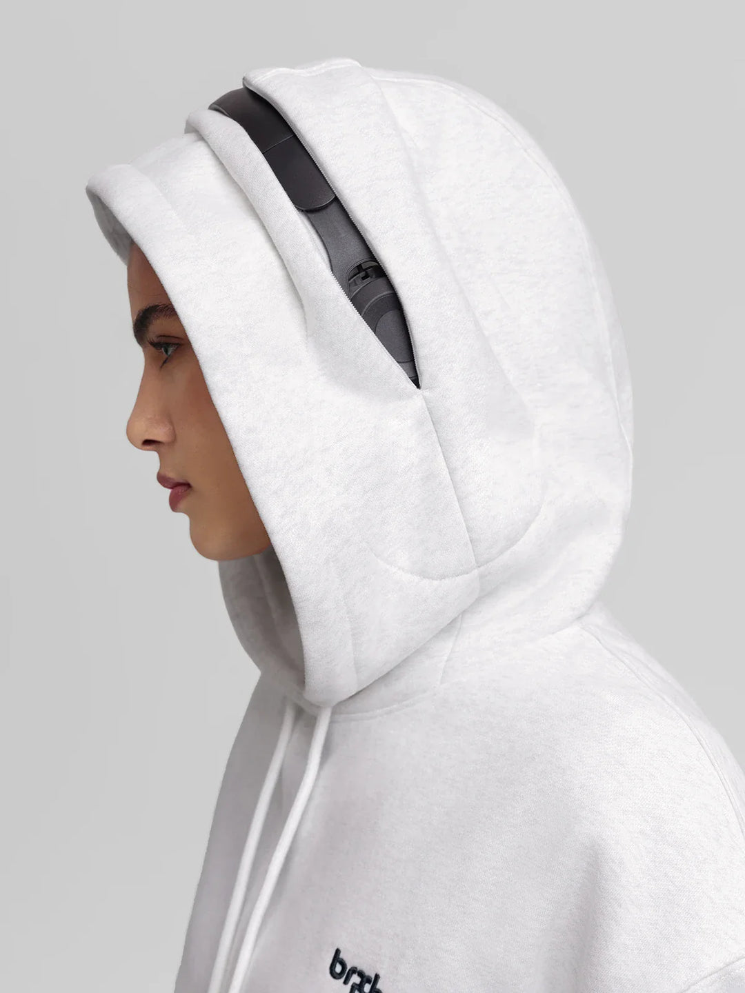 A model wearing a BRXL® Oversized Travel Pullover Hoodie with Headphone Slot