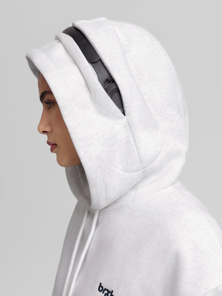 A model wearing a BRXL® Oversized Travel Pullover Hoodie with Headphone Slot