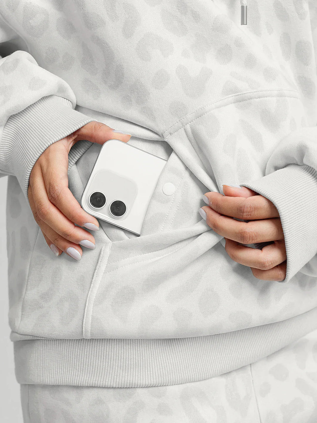 A model wearing a BRXL® Oversized Travel Pullover Hoodie with Headphone Slot