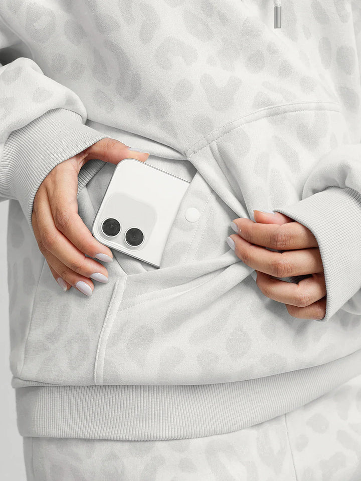 A model wearing a BRXL® Oversized Travel Pullover Hoodie with Headphone Slot