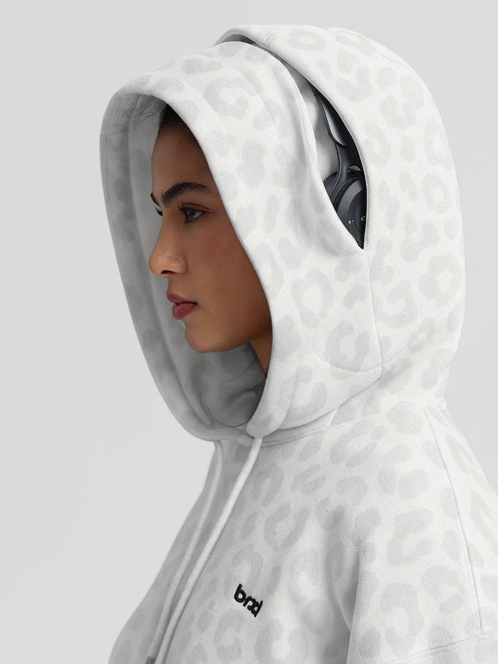 A model wearing a BRXL® Oversized Travel Pullover Hoodie with Headphone Slot