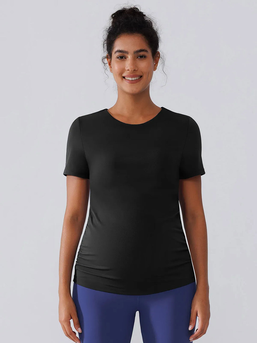 A model wearing a BRXL® Ruched Maternity T Shirts with Shelf Bra in
