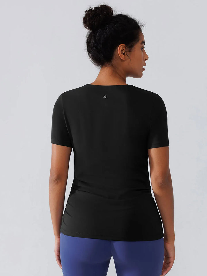 A model wearing a BRXL® Ruched Maternity T Shirts with Shelf Bra in