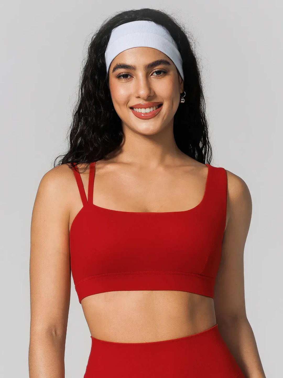 A model wearing a BRXL® Seamless Dual Style Square Neckline Sports Bra Red / XS