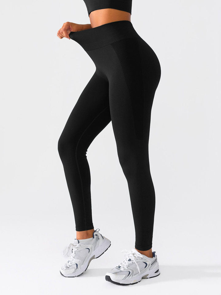 A model wearing a BRXL® Seamless High Waisted Butt-Lifting Leggings,Half Front Zipper Activewear Cropped Top in