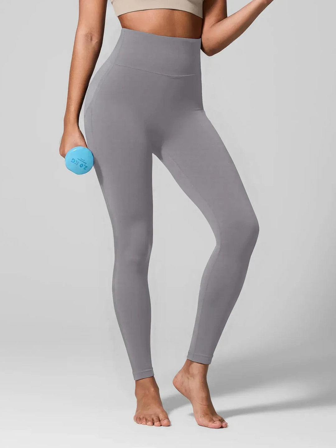 A model wearing a BRXL® Seamless High Waisted Tummy Control Butt-Lifting Leggings,Half Front Zipper Activewear Cropped Top in