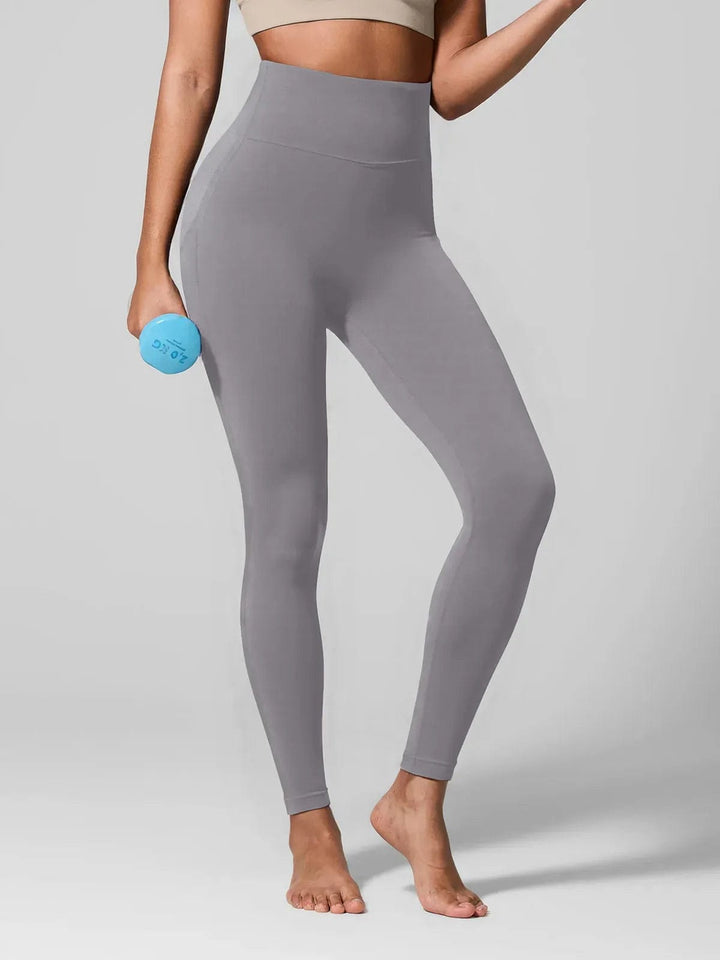 A model wearing a BRXL® Seamless High Waisted Tummy Control Butt-Lifting Leggings,Half Front Zipper Activewear Cropped Top in