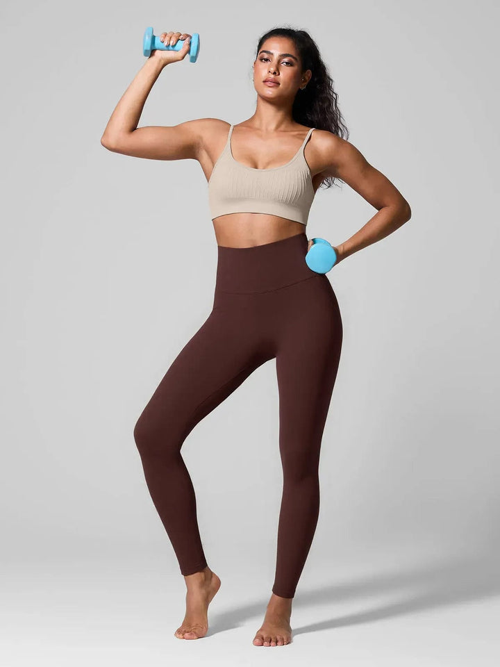 A model wearing a BRXL® Seamless High Waisted Tummy Control Butt-Lifting Leggings,Half Front Zipper Activewear Cropped Top in