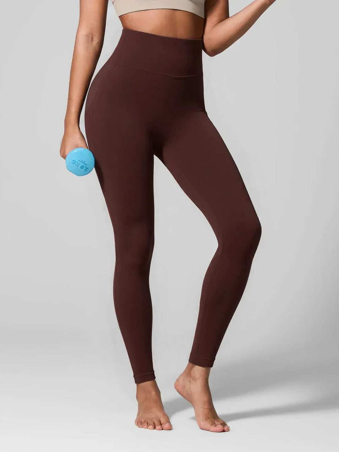 A model wearing a BRXL® Seamless High Waisted Tummy Control Butt-Lifting Leggings,Half Front Zipper Activewear Cropped Top in