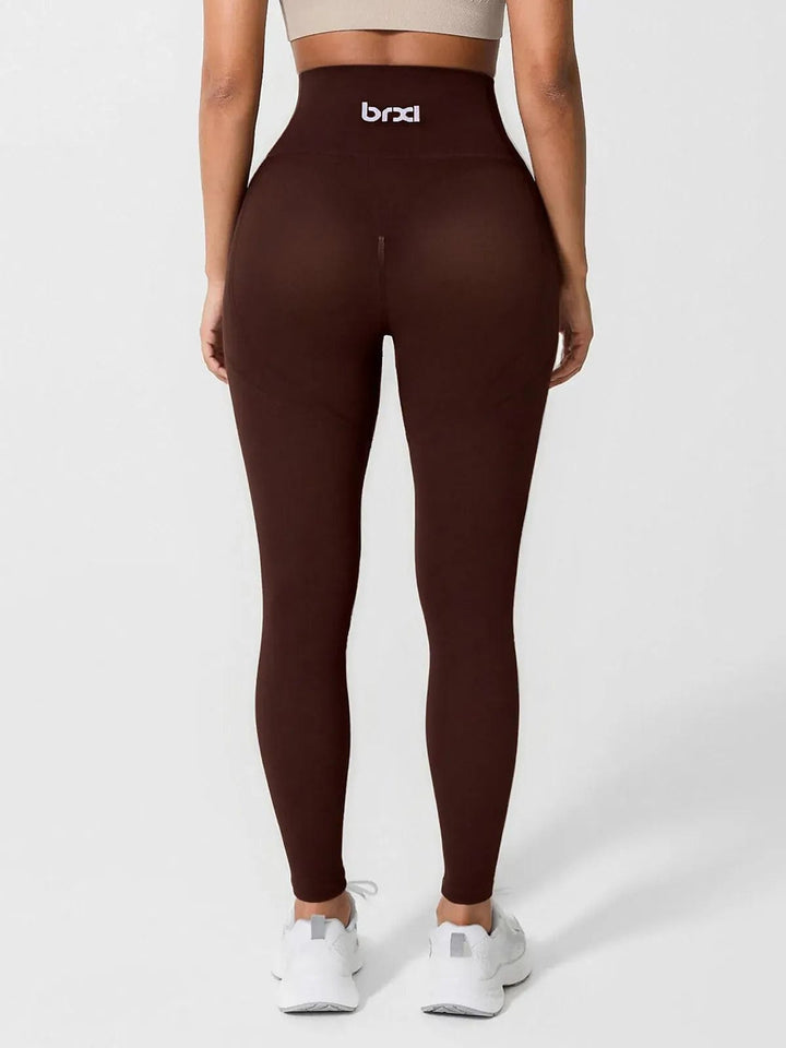 A model wearing a BRXL® Seamless High Waisted Tummy Control Butt-Lifting Leggings,Half Front Zipper Activewear Cropped Top in