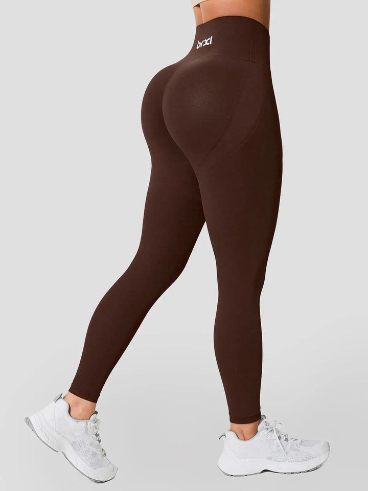 A model wearing a BRXL® Seamless High Waisted Tummy Control Butt-Lifting Leggings,Half Front Zipper Activewear Cropped Top in Legging / Brown / XS