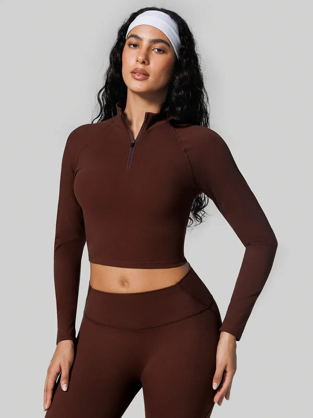 A model wearing a BRXL® Seamless High Waisted Tummy Control Butt-Lifting Leggings,Half Front Zipper Activewear Cropped Top in Set / Brown / XS