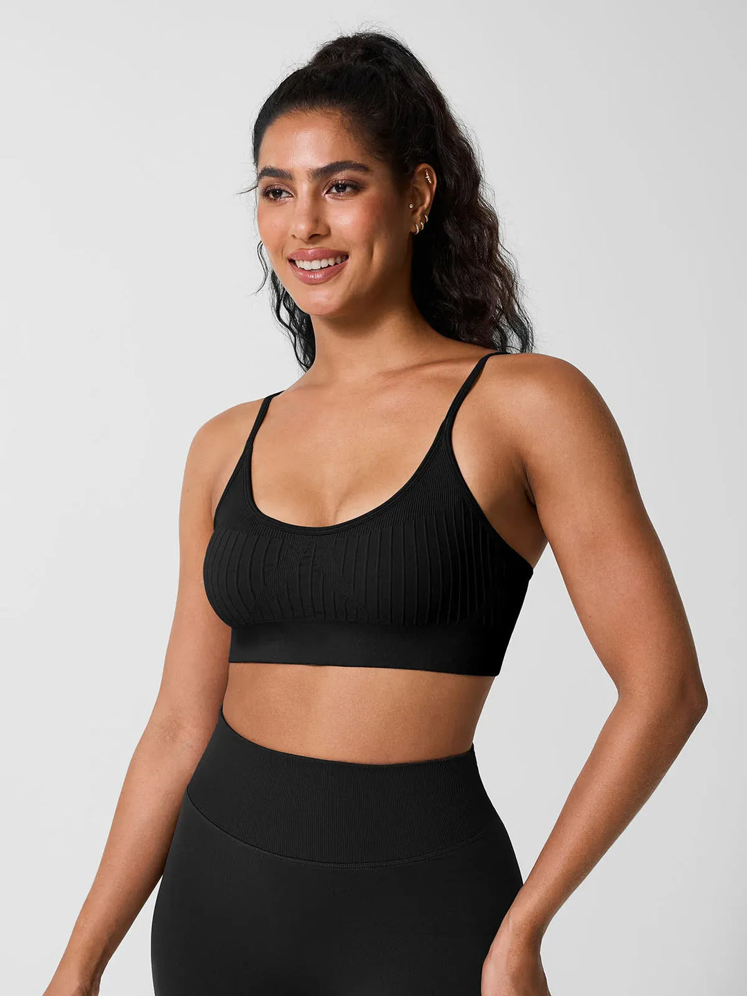 A model wearing a BRXL® Seamless Scoop Ribbed Sports Bra