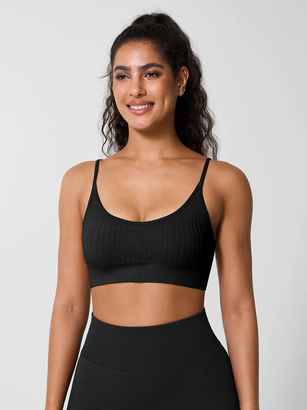 A model wearing a BRXL® Seamless Scoop Ribbed Sports Bra Black / XS