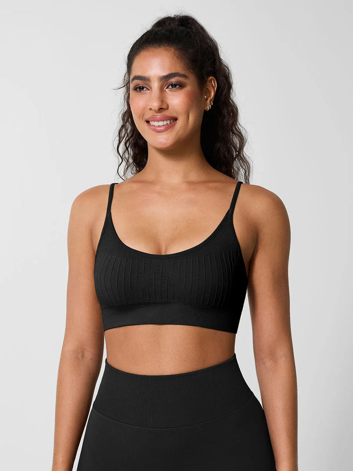 A model wearing a BRXL® Seamless Scoop Ribbed Sports Bra Black / XS