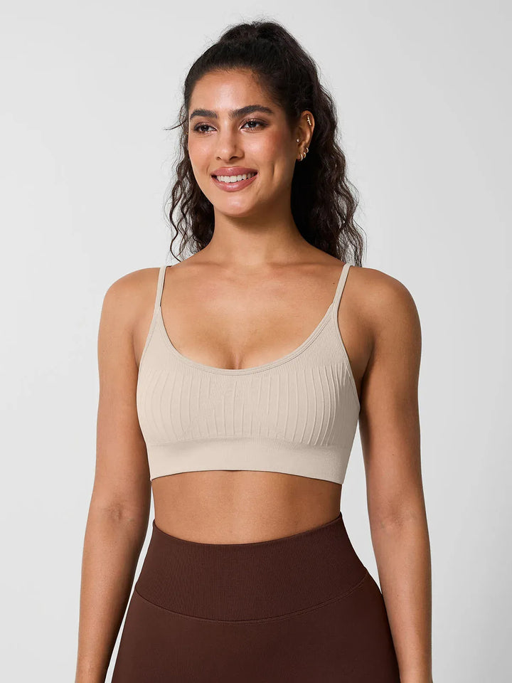 A model wearing a BRXL® Seamless Scoop Ribbed Sports Bra Brown / XS