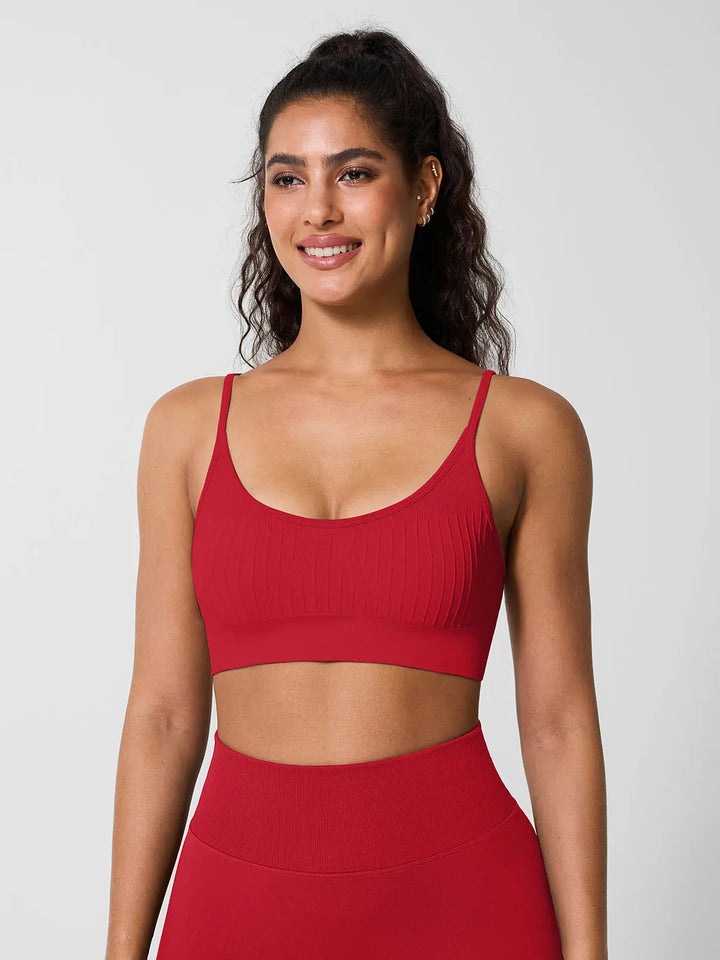 A model wearing a BRXL® Seamless Scoop Ribbed Sports Bra Red / XS