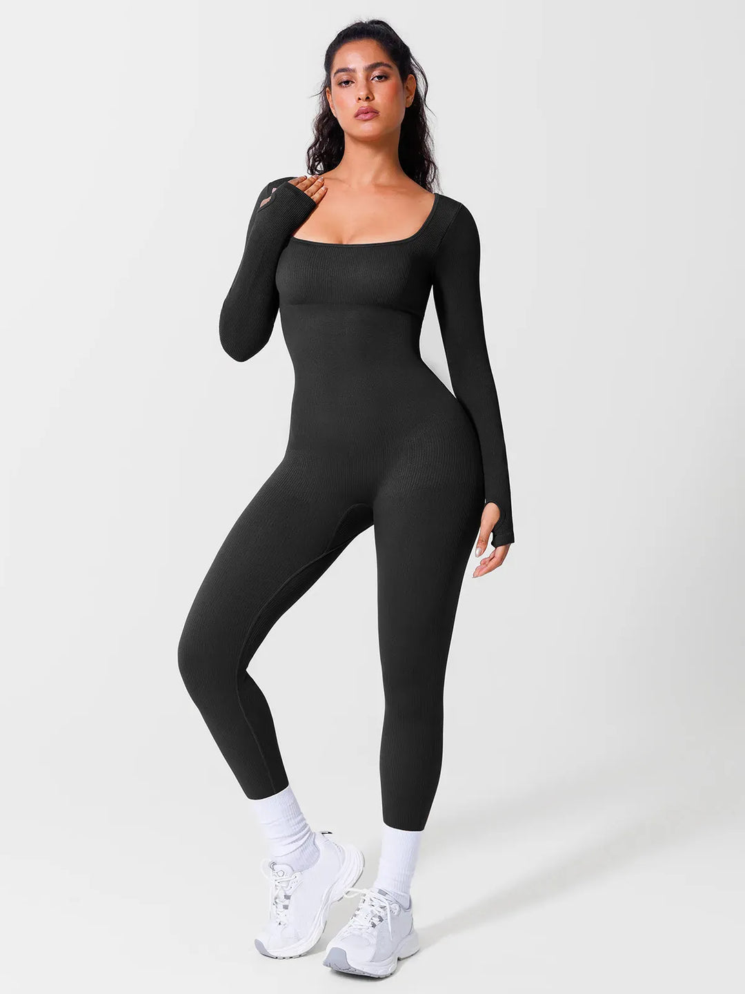 A model wearing a BRXL® Yoga Activewear Jumpsuit Winter Shapewear Long Sleeve Thumb Hole Jumpsuit in Black / XS