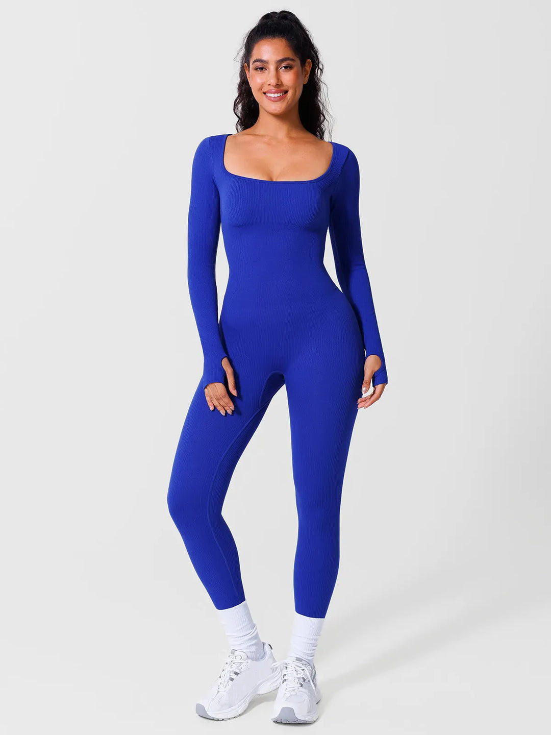 A model wearing a BRXL® Yoga Activewear Jumpsuit Winter Shapewear Long Sleeve Thumb Hole Jumpsuit in Blue / XS