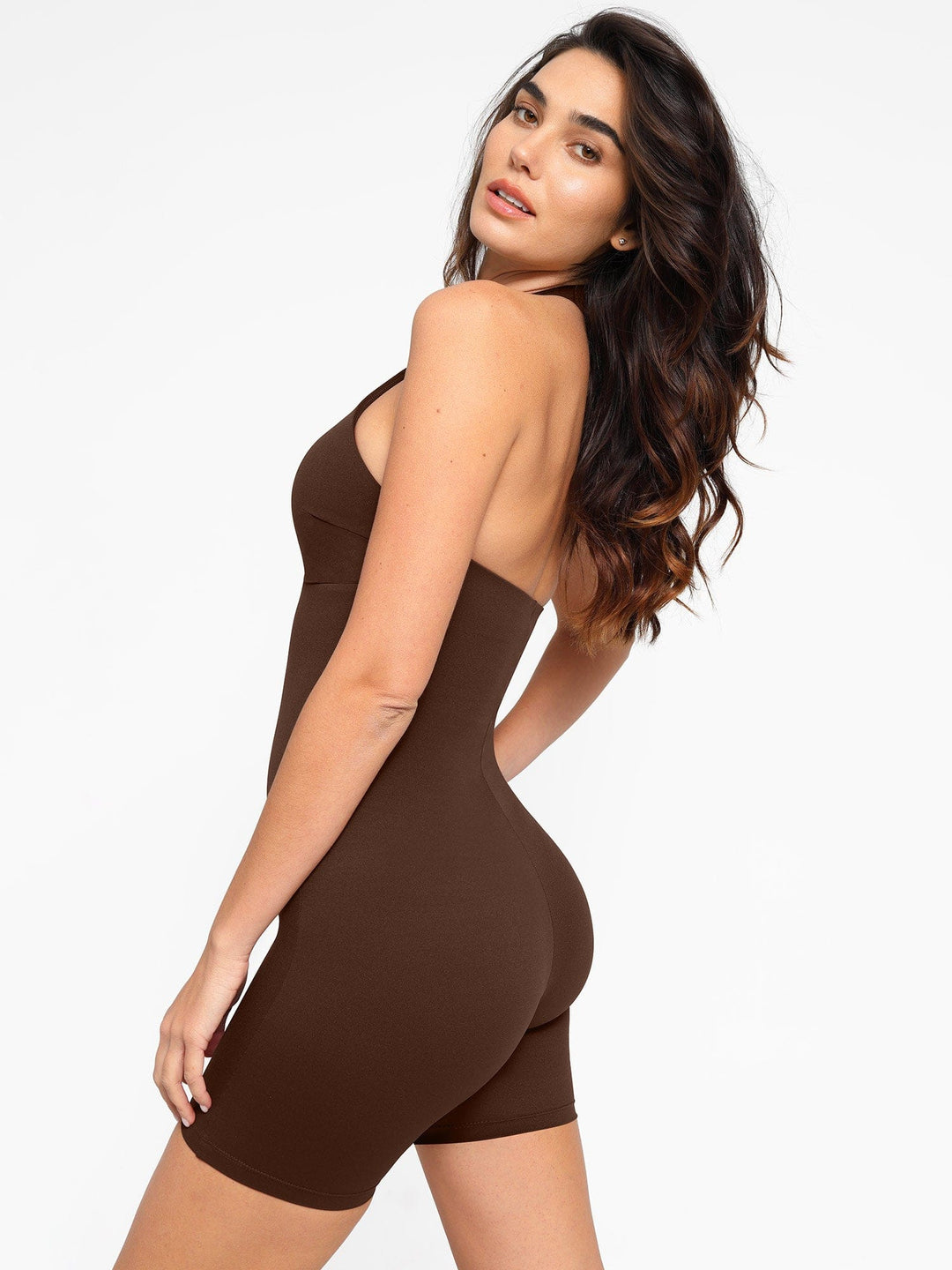 A model wearing a BRXL® Shapewear Sculpting Cutaway Halter Romper in