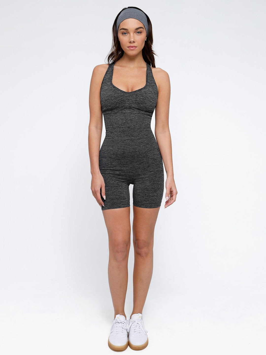 A model wearing a BRXL® Shapewear Seamless Sport Crossback Romper in