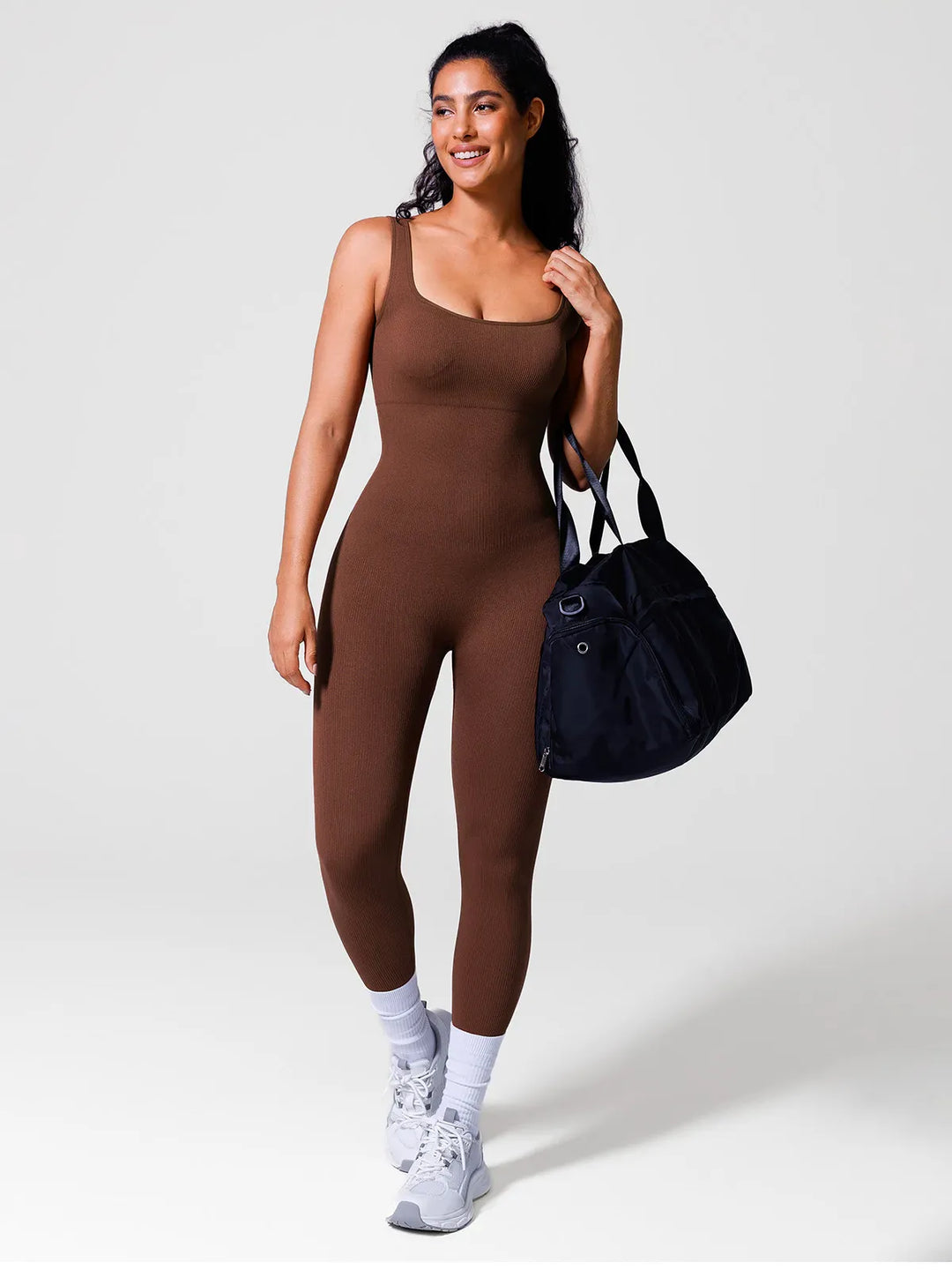 A model wearing a BRXL® Yoga Activewear Jumpsuit Shapewear Seamless Square Neck Tank Workout Jumpsuit in