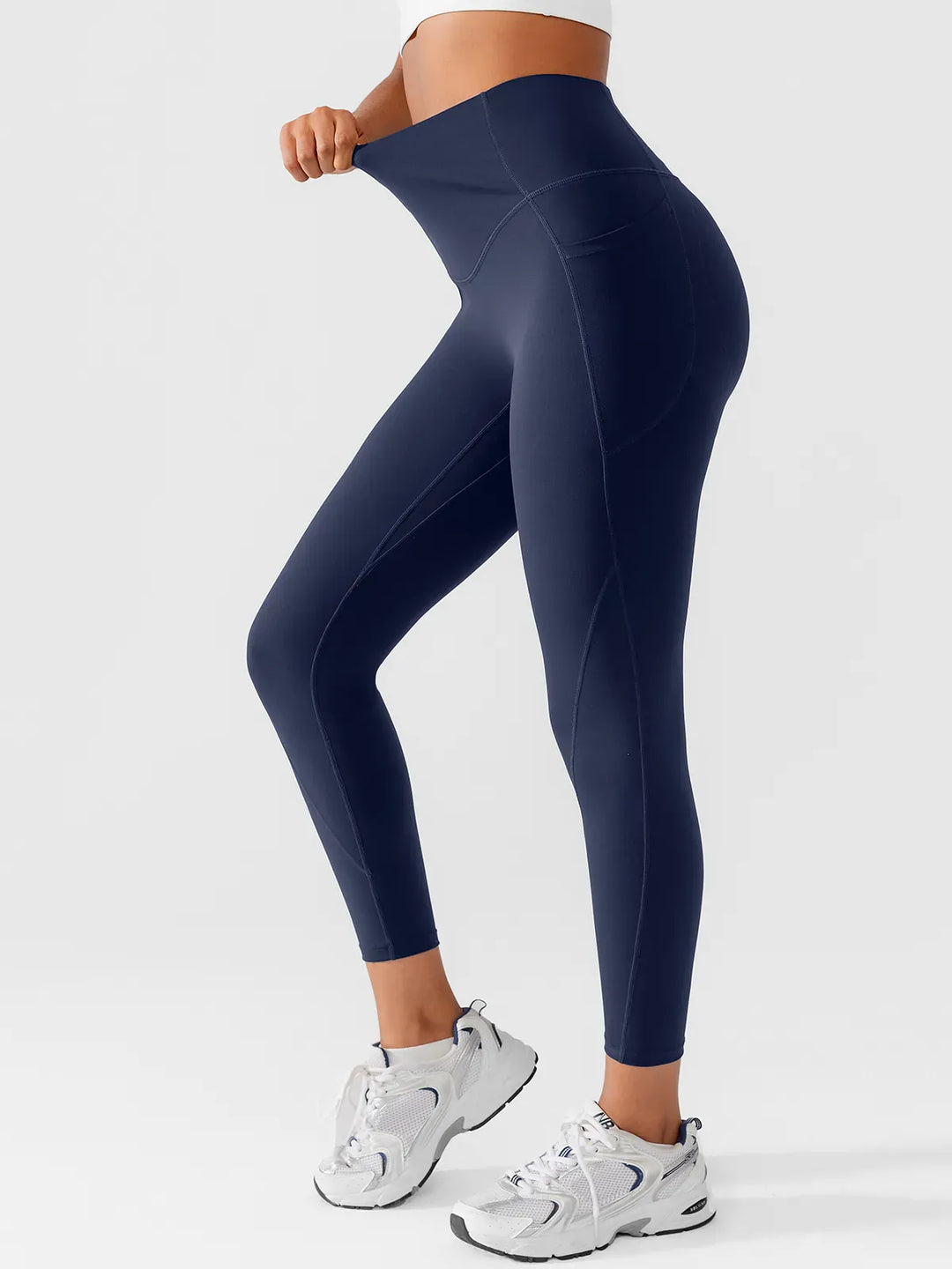 A model wearing a BRXL® Side Pocket Butt-Lift Leggings in