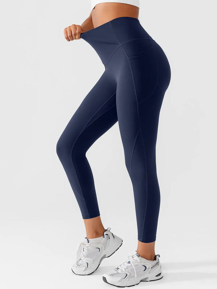 A model wearing a BRXL® Side Pocket Butt-Lift Leggings in