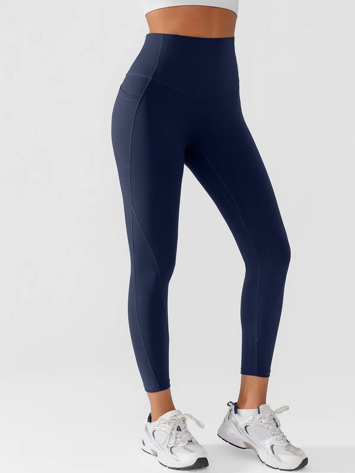A model wearing a BRXL® Side Pocket Butt-Lift Leggings in