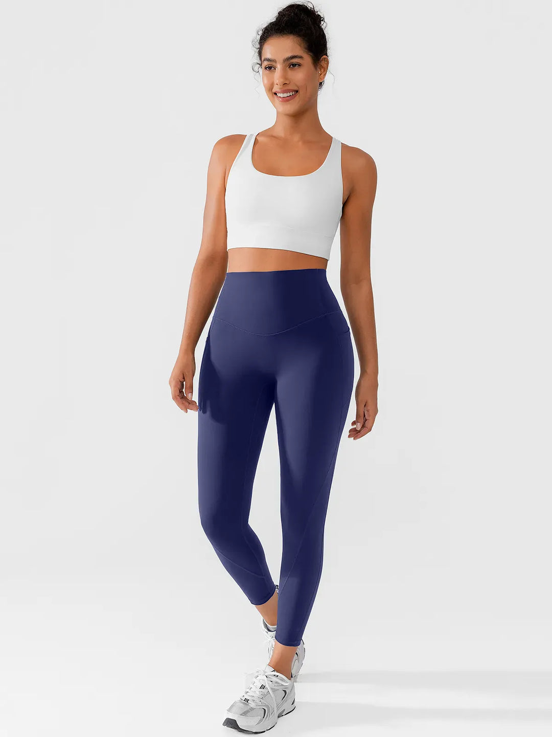 A model wearing a BRXL® Side Pocket Butt-Lift Leggings in