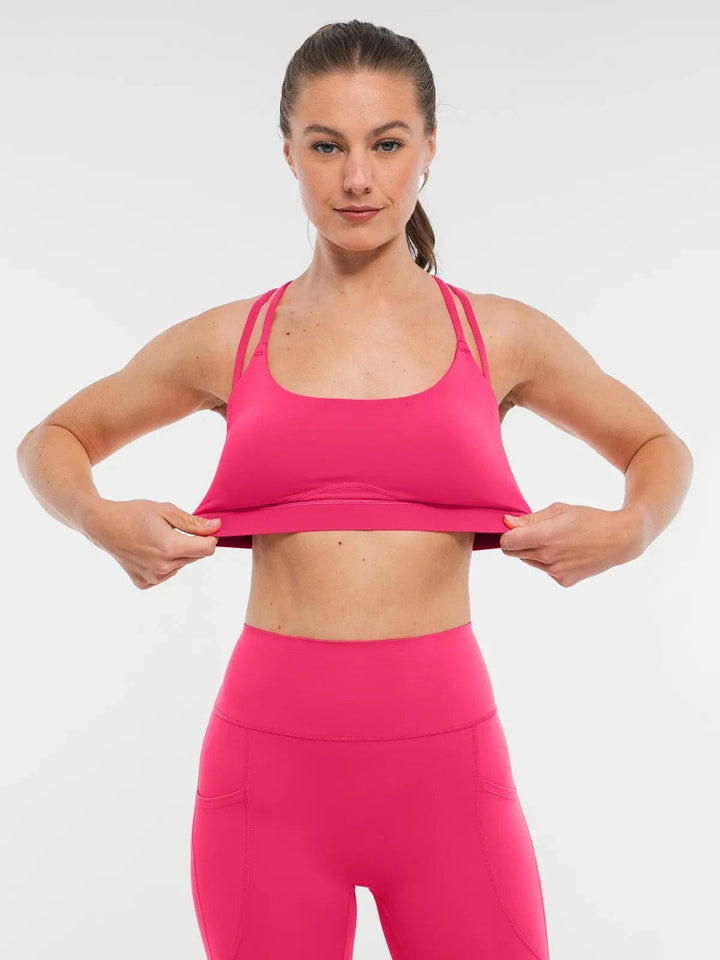 A model wearing a BRXL® Sports Bra Sculpted Shorts Sculpted Leggings Set in