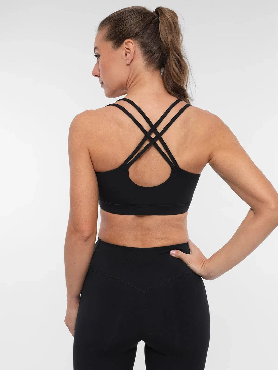 A model wearing a BRXL® Sports Bra Sculpted Shorts Sculpted Leggings Set in