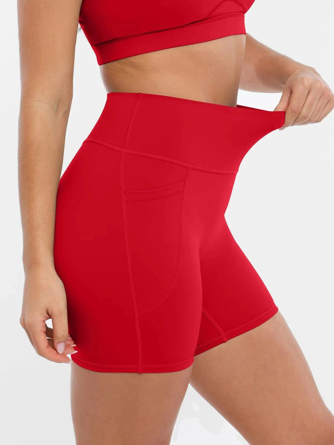 A model wearing a BRXL® Sports Bra Sculpted Shorts Sculpted Leggings Set in